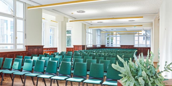 Heller Grete-Unrein-Raum im Volkshaus Jena mit Blick auf die Bankettbestuhlung aus grünen Stühlen.  ©JenaKultur, Karoline Krampitz